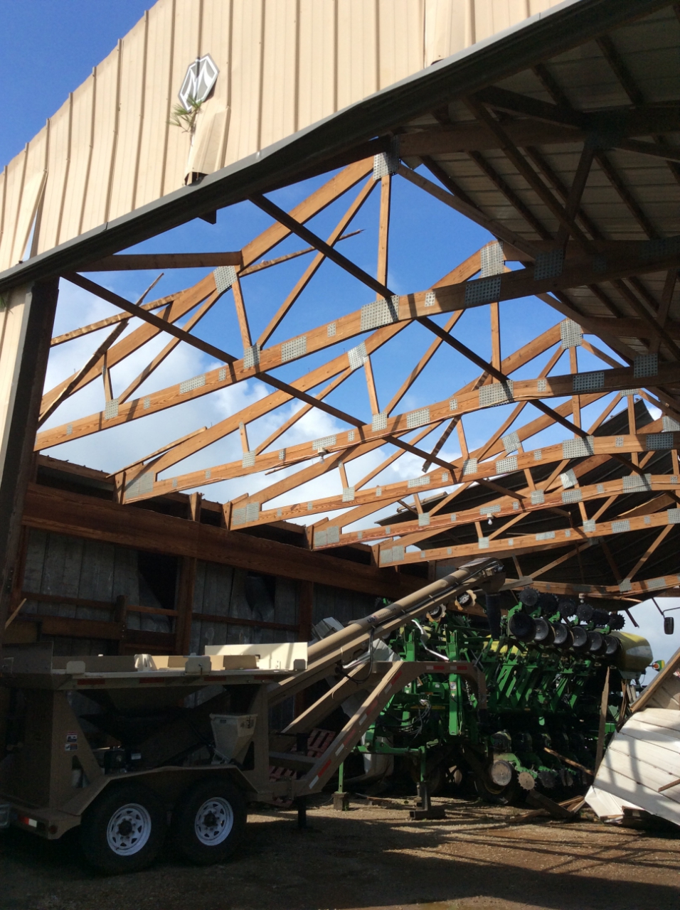 Much of a roof was removed from a machine shed